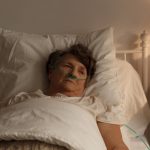 home-care-services-sick-senior-woman-in-bed-PA7H32M-Recovered